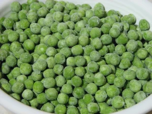 Frozen green peas with visible frost